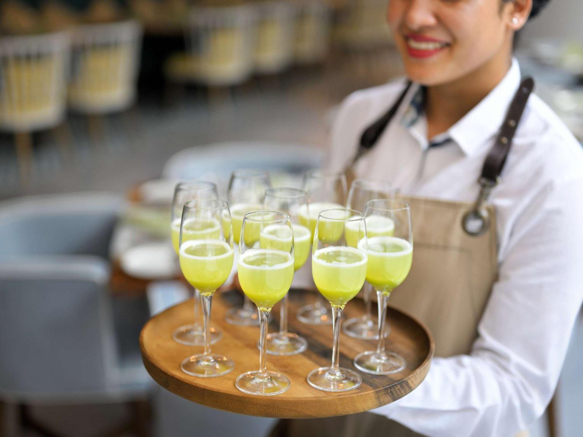 Moevenpick Hotel & Apartments Ghala Muscat Exterior photo A server holding a tray of cocktails