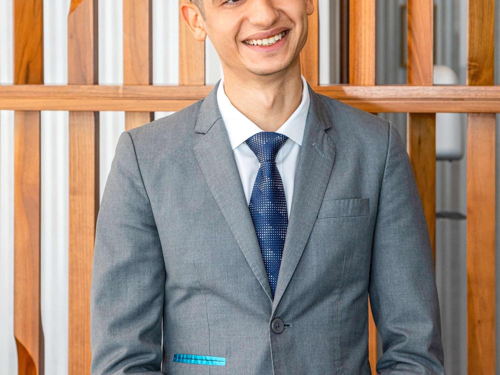 Moevenpick Hotel & Apartments Ghala Muscat Exterior photo A man wearing a suit